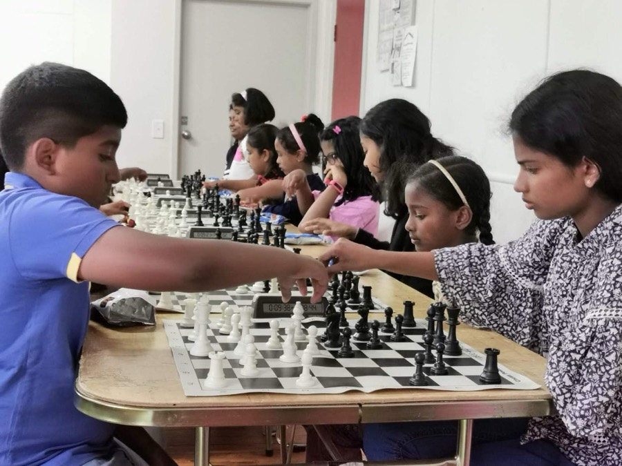 Group tournament in progress at long tables