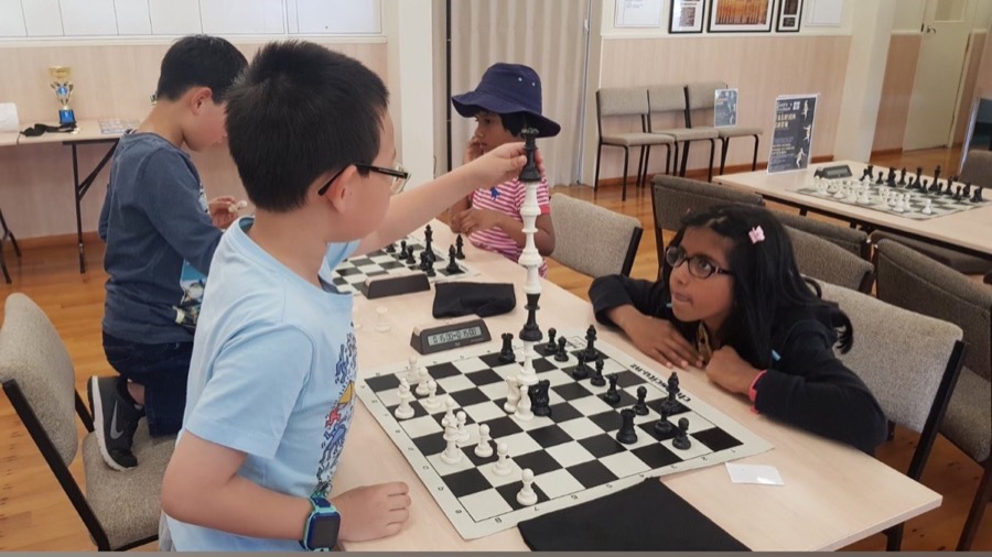 Students playing chess in a class