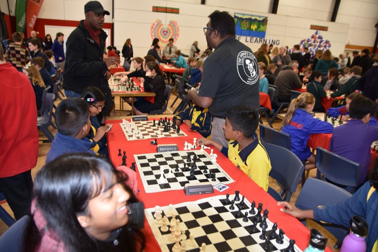 Roshan Gallage running a tournament round, coaching young players at the board